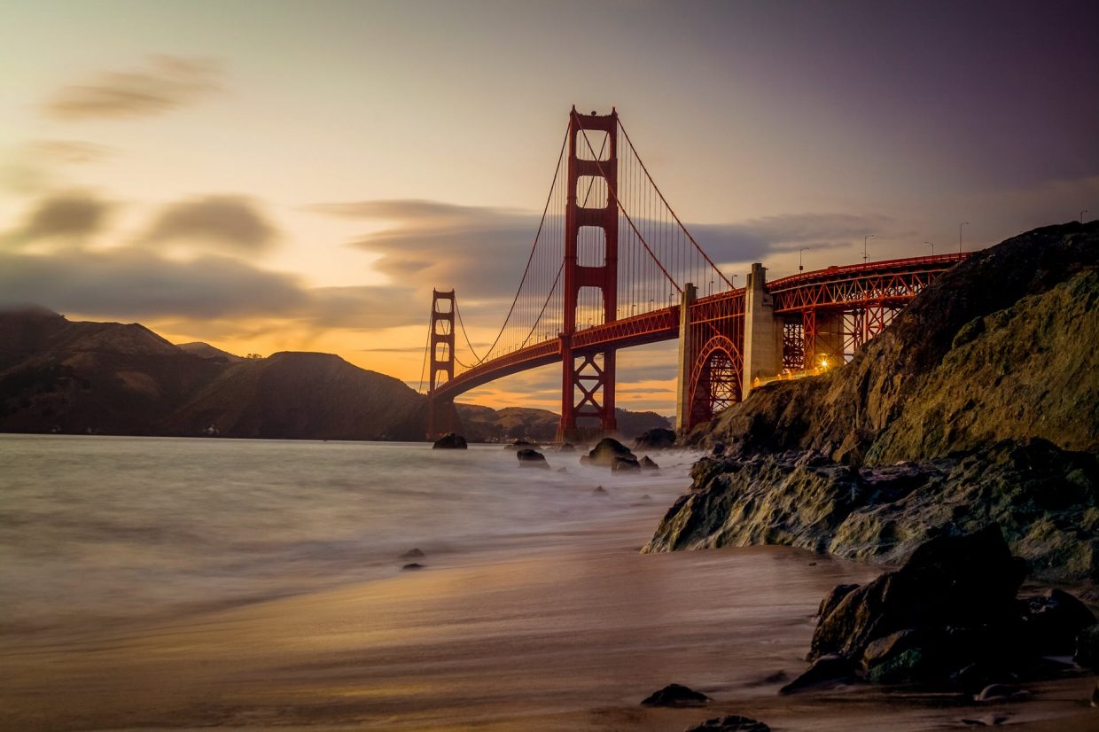 photography of red bridge under white and gray sky