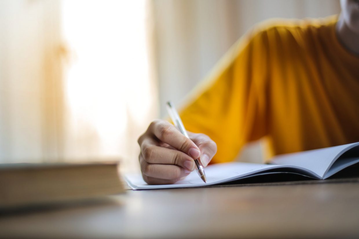 selective focus photo of person writing