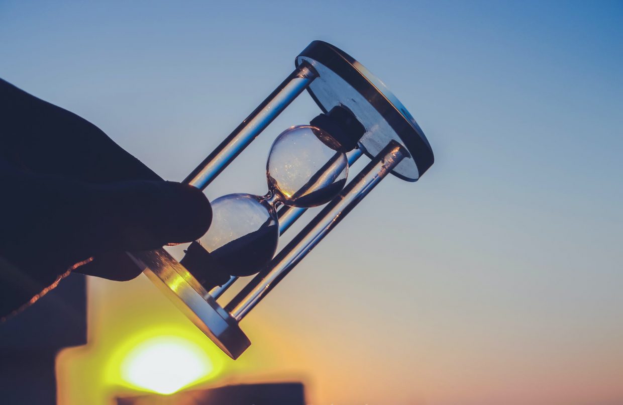 person holding hour glass