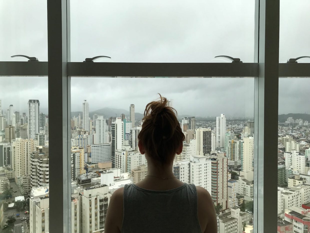 woman standing near glass window